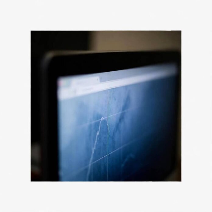 Off-kilter shot of hazy screen glow in dim room, post-midnight vibe.